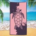 Detail of a microfiber beach towel featuring a pink and purple turtle design on the beach - Sea Turtle Beach Towel 11