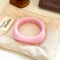 Close-up of pink marbled resin bangle with square structure on soft beige fabric - Geometric Rhombus / Inner Diameter 65mm / Pink