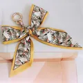 Detail of yellow daisy floral silk bow keychain with golden metal ring for handbags - No.11 (White with Yellow Flowers)