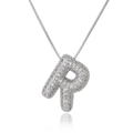 Macro shot of silver letter R pendant with sparkling zircons on a box chain - Letter R