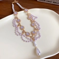 Multi-layer gold chain necklace with white pearls and sun-shaped charm on a beige plate - Rhinestone Bowknot Waterdrop Pendant Style