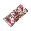 Detail of cross knot headband featuring vibrant red and yellow butterfly floral patterns - Red Yellow Floral Butterfly