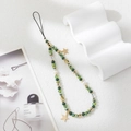 Detailed shot of beaded phone strap with green faceted beads and gold star charms - Green