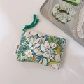 Detail of oil painting style floral cotton pouch with simple wish label and green zipper pull - Green Leaf Floral