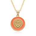 Close-up of golden Saint Benedict medal pendant with vibrant orange enamel detailing - Style A012