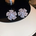 Close-up of flower stud earrings with sparkling cubic zirconia on a reflective surface - 4# Silver Earring Post - Silver-tone Clear Zircon Flower