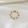 Beaded ring with gold finish beads, white pearls and a central orange focus bead - Orange