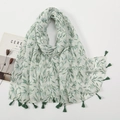 Detail of white cotton linen scarf featuring green leaf prints and fringe tassels - White Base Fresh Green Leaf Style (XB945-02)