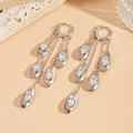 Detail view of silver tassel earrings with marquise-cut cubic zirconia stones - Silver