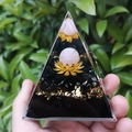 8cm crystal pyramid with pink sphere and gold lotus held by hand against green leaves - 8cm / Lotus Pink Sphere Style (9)