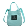 Minimalist light blue canvas bucket bag with adjustable shoulder strap and top handle - Lake Blue