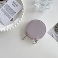 Detail of round purple leather coin purse with silver zipper and secure metal hook - Lavender
