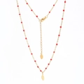 Detail of gold feather pendant and red rice beads on a polished stainless steel chain - Red (XN311-red)
