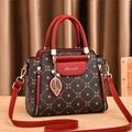 Elegant red and brown leather handbag with luxury geometric pattern and gold leaf charm - Coffee & Wine Red