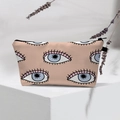 Detail of waterproof Evil Eye makeup bag with blue patterns on a beige surface - Beige Multi-Eye Design