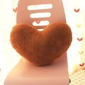 Plush heart-shaped decorative pillow in brown finish placed on a pink chair - Brown Heart