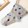 Gray cotton crew socks featuring colorful heart patterns in red, yellow and blue - One Size / Gray