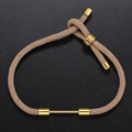 Detailed close-up of adjustable light brown braided cord bracelet with gold metal bar and clasp - Grey Brown