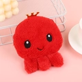 Detail of red plush octopus coin purse with a gold crown on a pink background - Red