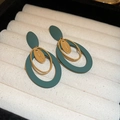 Close-up of matte green and gold geometric drop earrings with engraved gold tag - Silver Earring Post Style / Green Gold Combination