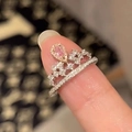 Detailed macro of a silver tiara ring featuring a pear-shaped pink stone and small diamonds - Starry Pear Pink Zirconia