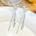 Detailed view of silver bow earrings with long tassels and sparkling accents - Bow Knot Branch Rhinestone Tassel Style (1895)