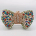 Detail shot of the colorful rhinestone bow clutch with a polished gold metal frame - Gold Multicolor