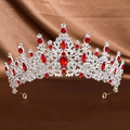 Close-up of vintage bridal crown with red gems and silver filigree on brown satin - Silver Red