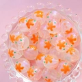 Macro shot of luminous 16mm star beads with orange starfish inside a glass bowl - Orange Flower Green Dot / 16mm Luminous