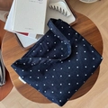 Detail of navy blue polka dot denim tote bag with simple wish side label on wood table - Polka Dot