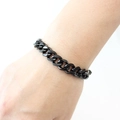 Mens thick black stainless steel Cuban link bracelet shown worn on a wrist - Black Style (YB-826BLK)