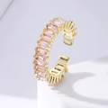 Detailed close-up of a gold C-shape ring featuring pink rectangular cut cubic zirconia stones - Pink