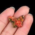 Handheld butterfly pendant crafted from natural orange and green spotted stone - Unakite