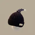 Deep brown knitted winter hat for kids with ear flaps and white pom-pom detail - Christmas Horn Hat Black (for Ages 2 Months To 2 Years)