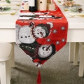 Red Christmas snowman table runner with decorative tassels on a festive dinner table - Snowman