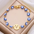 Gold Evil Eye bracelet featuring blue beads and a hollow letter V charm for women - Letter V
