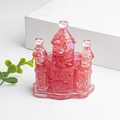 Pink resin fairy castle ornament with crystal fragments and glitter on white base - Watermelon Quartz