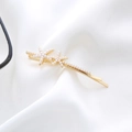 Detail of a golden starfish hair clip with white pearls on white silk fabric background - Double Starfish Bobby Pin