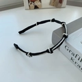 Elegant black woven headband featuring delicate white pearls in a minimalist design - 211228 Knotted