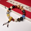 Detailed close-up of colorful multi-gemstone Bodhi seed prayer beads on a red book - 1st Gen Premium - Tianyi Style