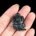 Deep green amethyst carved gemstone alligator figurine held in palm for scale - India Agate