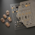 Detailed macro view of 5D gold embossed heart and line art nail stickers on nude nails - Black Gold Balloon Dog Heart Style (CO-275)