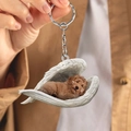 Detail of cute brown puppy sleeping in white angel wings acrylic keychain held by hand - Brown Poodle in Angel Wings (B)