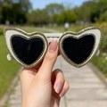 White heart-shaped sunglasses with black lenses and decorative gold rhinestones - White