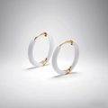 Close-up of gold and white enamel hoop earrings with secure snap-on closure detail - White