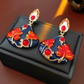 Close-up of vintage enamel fan earrings with red leaves and golden metal edges - Multi-color (Silver Earring Post)