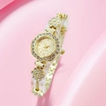 Detail of flower-shaped golden quartz watch with rhinestone accents and metal chain strap - Gold