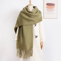 Thick olive green mohair scarf with fringe tassels worn by a model in white - Army Green