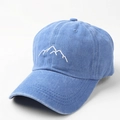 Detailed close-up of mountain peak embroidery on washed blue cotton baseball cap - Adjustable / Blue