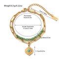 Detail of stainless steel bracelet with green natural stones and golden sun pendant - Gold/Green Beads/Sun Charm